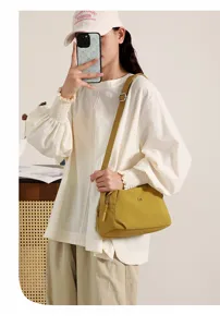 Stylish yellow nylon crossbody shoulder bag for women, minimalist casual shell bag daily use.