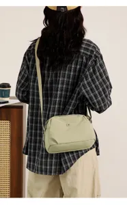 Casual nylon cross-body bag detail, lightweight daily shoulder bag with adjustable strap and chic look.
