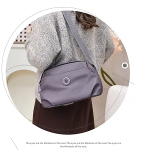Detailed view of grey nylon crossbody shoulder bag, lightweight casual multi-layer design.