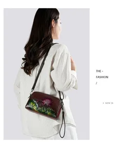 Retro embossed lotus leather crossbody bag detailed view showing exquisite floral craft.