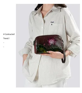 Vintage embossed leather women handbag with elegant lotus flower carving, chic ethnic style clutch.