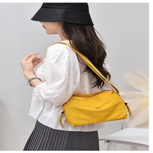Stylish yellow nylon shoulder bag for women, lightweight casual crossbody daily handbag.