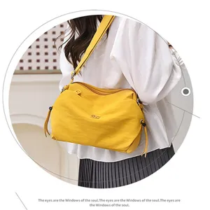 Nylon crossbody shoulder bag detail, lightweight casual design in bright yellow color.