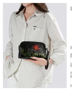 Vintage embossed lotus leather shoulder bag for women, stylish ethnic daily clutch purse.