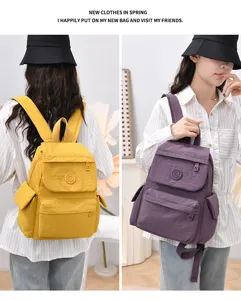Detail view of casual nylon backpack with multiple compartments, daily travel student bag.