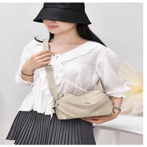 Detail view of casual nylon crossbody bag with wide strap and multi-pocket daily design.
