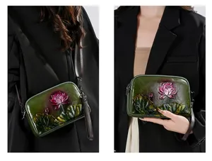 Detailed view of retro embossed lotus leather shoulder bag, vintage ethnic style strap.