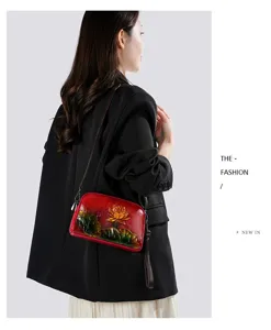 Retro embossed leather shoulder bag with artistic lotus carving design for women and ladies.