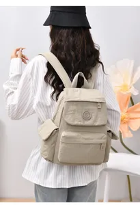Lightweight casual nylon backpack for women, stylish travel daypack with multiple pockets.