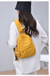 Casual retro yellow nylon mini backpack detail view, lightweight travel daypack for women.