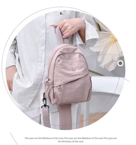 Detailed view of the casual pink nylon mini backpack, lightweight and stylish daily bag.