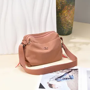 Women's nylon crossbody bag casual shoulder bag with wide strap and double zippers.