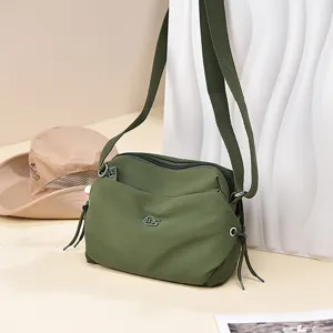 Casual nylon crossbody bag for women, lightweight shoulder bag with wide strap and zip.