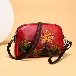 Vintage leather crossbody bag with embossed lotus design, elegant Chinese style shoulder bag.