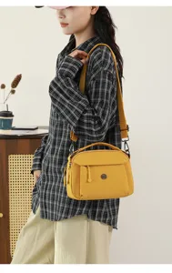Stylish casual yellow nylon crossbody bag for women with multi pockets and shoulder strap.