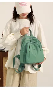 Casual nylon backpack for women, stylish travel daypack with multiple pockets and versatile design.
