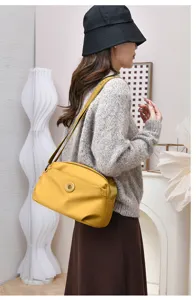 Minimalist nylon shoulder bag detail view, casual lightweight crossbody bag for women.