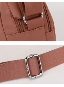 Casual nylon crossbody bag detail showcasing durable fabric, neat stitching, and metal hardware.