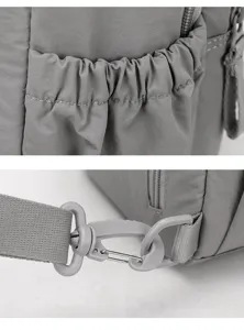 Grey nylon multi-functional backpack detail showing elastic side pocket and strap buckle.