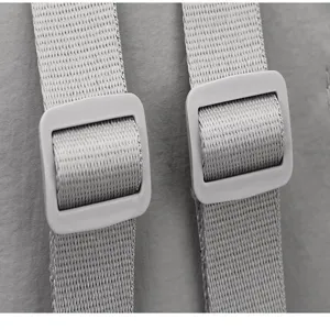 Detail shot of the backpack strap and adjustable buckle, showing durable material.