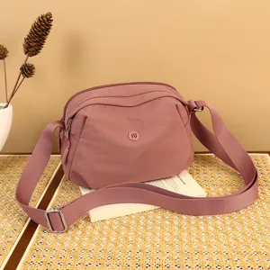 Minimalist nylon crossbody shell bag for women stylish casual shoulder bag with wide strap.