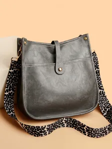 Grey crossbody bag for women, chic messenger shoulder bag with trendy leopard strap.