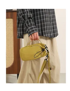 Korean style casual nylon crossbody bag with front zip pocket and stylish drawstring.