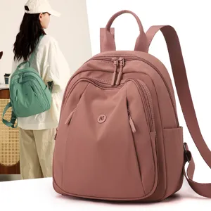 Casual nylon backpack for women, stylish travel daypack with multiple compartments and pockets.