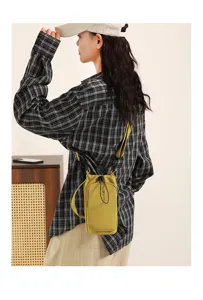 Korean style minimalist yellow mini crossbody phone bag with drawstring and adjustable strap.