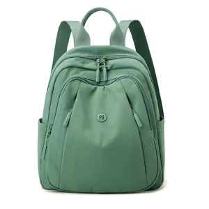 Casual green nylon backpack for women, multi-pocket stylish travel daypack front view.