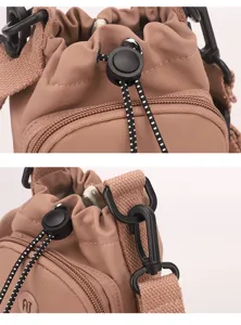 Detailed view of casual nylon drawstring crossbody bag with black hardware and zipper pocket.