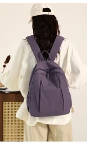 Detail shot of purple casual nylon backpack, featuring shoulder straps and zipper design for daily use.