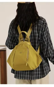Stylish nylon dumpling backpack detail, versatile casual travel daypack with secure zip pockets.