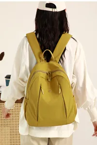 Stylish yellow nylon backpack for women, large capacity casual daypack for daily use and travel.