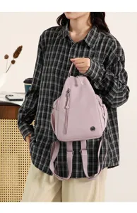 Detailed close-up view of women's casual nylon convertible backpack in light purple color.
