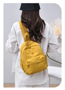 Detail shot of the stylish yellow casual backpack worn by a model, showing daily wearing style.