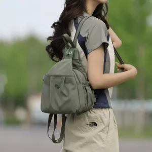 Stylish green nylon casual backpack for women, multi-pocket commuting shoulder messenger bag.