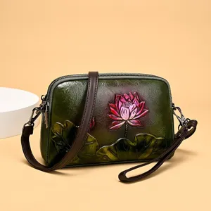 Vintage embossed leather crossbody bag for women, ethnic lotus flower design shoulder handbag.