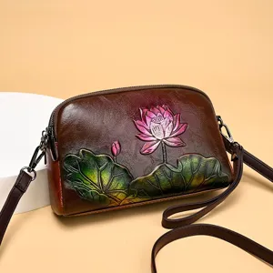 Vintage embossed leather shoulder bag with artistic lotus pattern for women elegant crossbody.