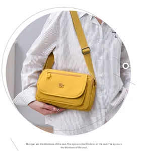 Detailed view of the yellow multi-layer nylon crossbody shoulder bag, lightweight and practical.