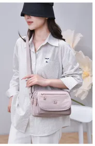 Fashionable multi-layer lightweight large-capacity nylon crossbody shoulder bag for women daily use.