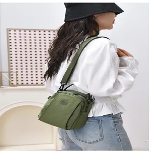 Casual nylon crossbody bag for women, multi-layer shoulder bag with adjustable strap.
