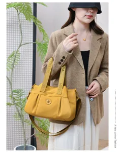 Stylish yellow waterproof tote bag with shoulder strap, large capacity design for daily use.