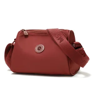 Water-resistant nylon crossbody bag for women, casual stylish shoulder bag with wide strap.