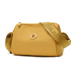 Yellow women's waterproof crossbody shoulder bag with stylish wide strap and gold hardware.