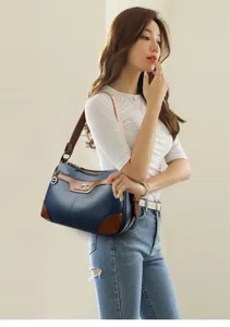 Shoulder bag detail view showing blue and brown PU leather design, metal hardware and strap.