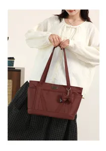 Detailed view of women casual tote bag featuring bow pendant and shoulder carry design.