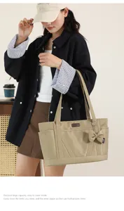 Casual large capacity tote bag with bow pendant, commuter nylon shoulder bag for women daily use.