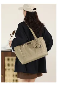 Large capacity commuter tote bag with bow detail, stylish shoulder bag for daily work use.
