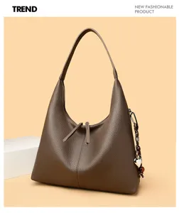 Stylish brown leather underarm shoulder bag for women, versatile casual tote with charm.